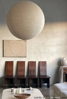 a living room filled with furniture and a large light fixture