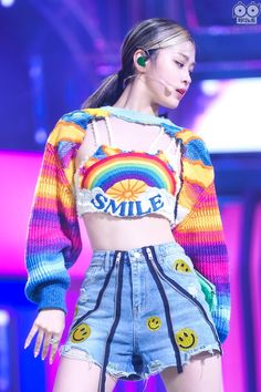 a woman in shorts and a crop top on stage