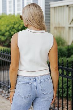 This sleeveless button-down top combines classic elegance with contemporary style. This sleeveless cream button-down top is a versatile wardrobe staple that seamlessly transitions from day to night! Crafted from a blend of viscose and nylon, it offers a luxurious feel with a lightweight and breathable texture. Whether you're headed to the office, meeting friends for lunch, or enjoying a casual outing, this top offers effortless style and comfort. Pair with tailored trousers or a pencil skirt for a polished office ensemble; or style with jeans and sandals for a chic yet relaxed daytime look. Bright Colors Fashion, Destructed Jeans, Loungewear Dresses, Office Meeting, Meeting Friends, Casual White Dress, Versatile Wardrobe, Power Dressing, Strappy Sandals Heels