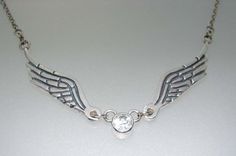 Hello!  This necklace has two sterling silver wings that are handcarved then cast into sterling silver. To make these wings more unique I carved the wing lines on the back too. Each wing is 1 1/2 inches long. In the centre is a genuine bezel set 6mm white topaz. The sterling silver chain part is adjustable to 16 or 18inches. Silver Winged Engraved Jewelry, Engraved Winged Sterling Silver Jewelry, Wing-shaped Sterling Silver Necklaces For Anniversary, Silver Wing-shaped Fantasy Jewelry, Elegant Silver Winged Necklace, Elegant Winged Silver Necklace, Fantasy Silver Wing-shaped Jewelry, Elegant Sterling Silver Winged Necklace, Silver Wing-shaped Sterling Silver Necklace