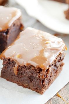 two brownies with frosting sitting on top of each other