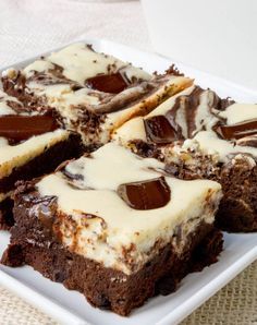 there are many pieces of chocolate cake on the white plate and one is cut into squares