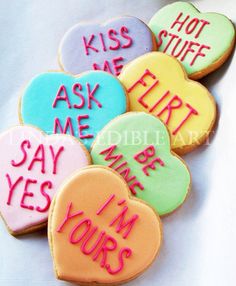 some cookies that have been decorated to say kiss me, ask me, and be your own