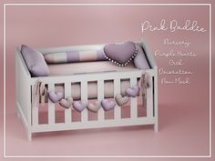 there is a baby crib with pink and purple hearts on the bottom, along with other items