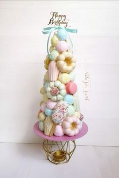 a birthday cake made out of cupcakes and marshmallows on a stand