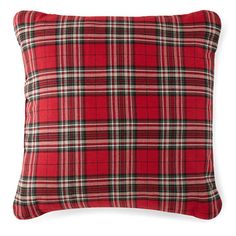 a red plaid pillow on a white background