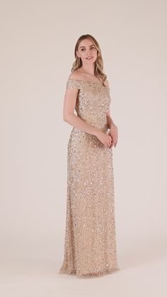 a woman in a gold sequin gown posing for the camera with her hands on her hips