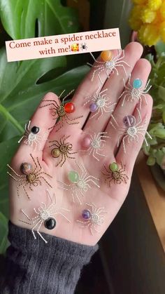 a person holding out their hand with lots of spider webs attached to the fingers