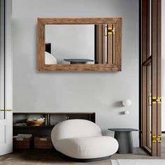 a living room with a white chair and mirror on the wall, in front of a door