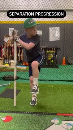 a young boy is practicing his batting skills