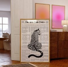 the new york times poster is displayed in front of a wooden cabinet and dresser with an animal print on it