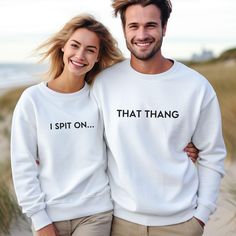 two people standing next to each other wearing sweaters that say i spit on, that thang