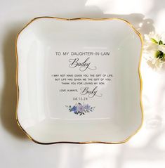 a white and gold plate with the words to my daughter - in - law