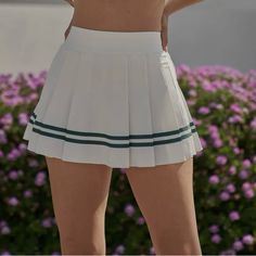 Gear Up For Victory On The Court Or Trail With This A-Line Tennis Skirt Featuring Comfortable Inner Shorts And On-Trend High Waist. Designed With Pleated Details Comfy Inner Short With Side Pocket Elastic Waistband Asymmetric Pleated Skirt High-Rise & Hits Above Upper Thigh White High-waist Pleated Tennis Skirt, White High Waist Pleated Tennis Skirt, High Waist White Pleated Tennis Skirt, White Preppy Mini Tennis Skirt, Preppy White Mini Tennis Skirt, White Pleated Bottoms For Day Out, White Short Tennis Skirt For Day Out, White Pleated Tennis Skirt For Day Out, White Pleated Tennis Skirt In Preppy Style