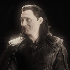 black and white photograph of a man dressed as thor from the avengers movie, looking to his left