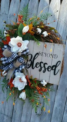 a wooden sign that says beyond the blessed with flowers and leaves hanging on it's side