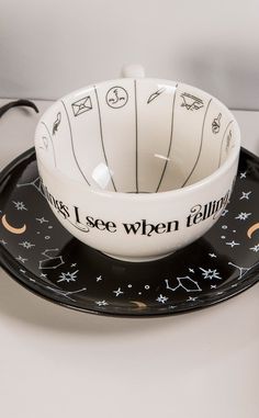 The truth lies in the leaves! This unique teacup can both serve a generous brew and help you interpret the meaning of your tea leaves when you're finished! The inside is printed with symbols you may see in the leaves while the outside is printed with the phrase "Mysterious Things I See When Telling Fortunes In Tea". It comes with a contrasting black saucer printed with constellations and gold foil and an instructional leaflet on how to read tea leaves. Truly a stunning piece to gift to yourself Read Tea Leaves, Mysterious Things, Witchy Gifts, Truth And Lies, House To Home, Fortune Telling, Tea Leaves, Cooking Timer, The Meaning