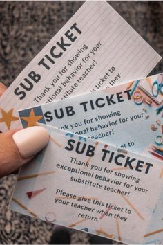 someone is holding two tickets for sub ticket