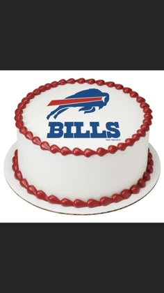 a buffalo bills logo cake on a white plate with red piping around the edges