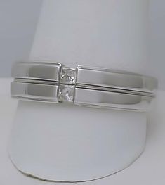 a white gold wedding ring set with a princess cut diamond