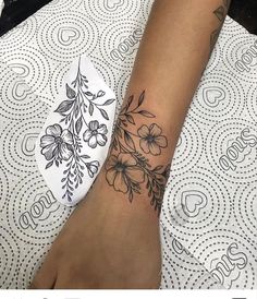 a woman's foot with a flower tattoo on it