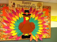 a bulletin board with a turkey wearing a pilgrim hat on it's head and the words happy thanksgiving