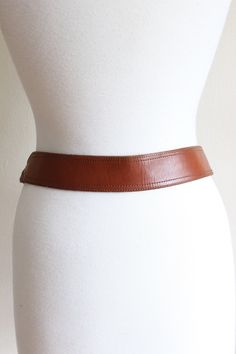 "Vintage 1970s western style belt in brown genuine leather with brown stitching, braided detail at sides, silvertone metal buckle, leather loop, and silvertone metal belt tip. Good vintage condition - overall wear including scuffs and marks. Measurements: buckle: 1.875\"W x 1.5\"H belt width: .1.75\" total belt length: 39.25\" buckles at: 34\" - 36\" genuine leather Please, take these measurements into consideration and compare them to a similar item of your own to ensure a good fit. All sales f Metal Belt, Western Belts, Metal Buckles, Western Fashion, 1970s, Brown Leather, Silver Tone, Genuine Leather, Buckle