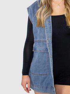 Stay comfortable and casual in this Denim sleeveless vest from Denim. This oversize sleeveless denim vest features a collar with a snap button closure, front patch pockets, and a medium wash. Pair this vest with your favorite t-shirt and shorts for an easy look that you can wear anywhere! Denim sleeveless vest Collared Snap button closure Oversized patch front pockets Medium wash Trendy Denim Vest Top For Fall, Trendy Fall Denim Vest Top, Sleeveless Denim Jacket With Pockets For Fall, Sleeveless Denim Jacket For Spring Streetwear, Sleeveless Denim Vest With Pockets For Streetwear, Sleeveless Denim Vest For Spring Streetwear, Casual Light Wash Vest For Fall, Spring Utility Denim Sleeveless Vest, Spring Utility Sleeveless Denim Vest