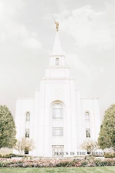 a large white building with a gold statue on top and the words jesus is the king above it