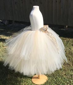 This listing includes an ivory and champagne/beige tutu with a gold glitter bow. This listing if for waist sizes up to 34 1/2" can be made larger if interested contact me for a special listing. Other colors also available. The ivory and champagne/beige tutu pictured is the 19-24” length range with a longest layer of 20” and top layer of 17”. Tutu can be all one length or the dual lengths. **please just note the length you would like or lengths you would like upon checkout***Thank you for shoppin Gold Ruffled Tutu Dress For Wedding, Cream Tutu Dress For Pageant, Gold Ruffled Tutu Dress For Pageants, Gold Ruffled Tutu Dress For Pageant, Gold Tulle Tutu Dress With Ruffles, Cream Tulle Tutu Dress For Pageants, Cream Tulle Tutu Dress For Pageant, Cream Tulle Tutu Dress For Wedding, Princess Style Cream Tutu Dress For Pageants