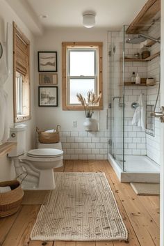 a bathroom with wood floors and white tile on the walls, along with a rug