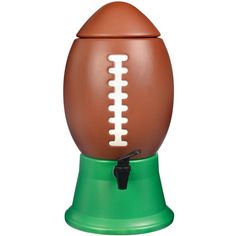 an egg shaped like a football sitting on top of a green stand