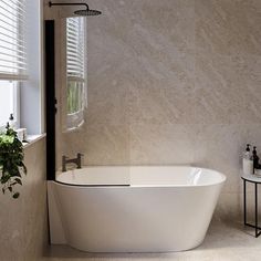 a white bath tub sitting next to a window