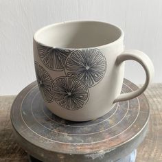 a coffee cup sitting on top of a wooden table