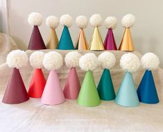 there are many different colored cones with pom - poms on top of them