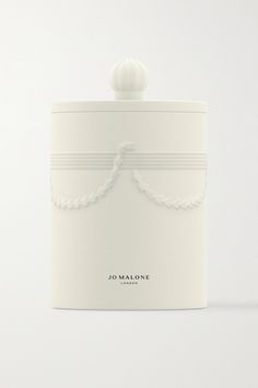 a white canister with a rope on the top and a ball in the middle