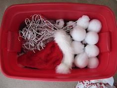 a red container filled with white cotton balls