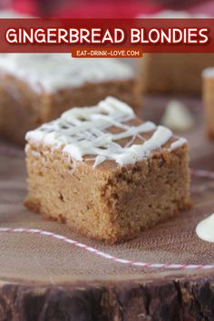 gingerbread blondies with white icing are on a wooden board and have been cut into squares