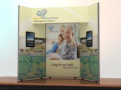 an exhibit stand with a large photo on it's front and side panels that have the same image as each other