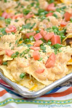 an enchilada dish with tortilla shells and tomatoes