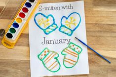 a piece of paper that says, smitten with january next to some crayons