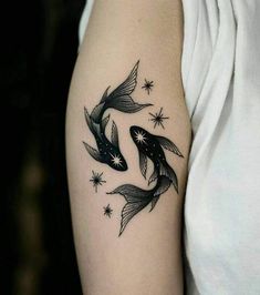 two black and white koi fish tattoo on the left arm