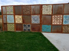 a fence made out of different types of tiles