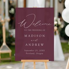 an easel with a sign that says welcome to the wedding of madison and andrew