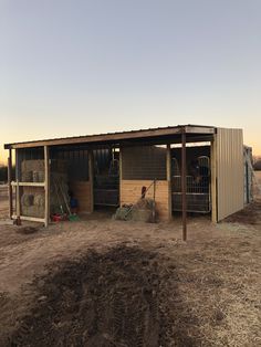 a horse barn with hay in the back