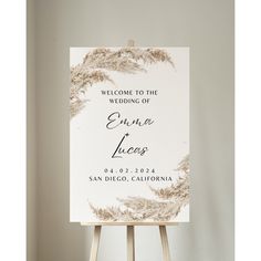 an easel with a sign that says welcome to the wedding of evana and lucas