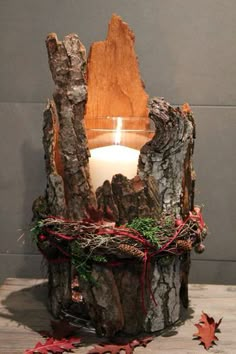 a candle that is sitting inside of a tree stump