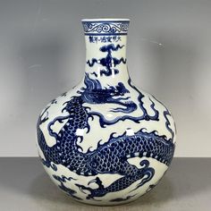 a blue and white vase with a dragon on it