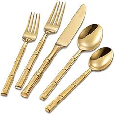 gold colored utensils and spoons are arranged in a row on a white background