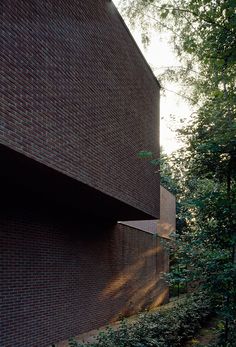 an instagramted photo of a brick building with trees in the foreground and text that reads, save saved from divisable com